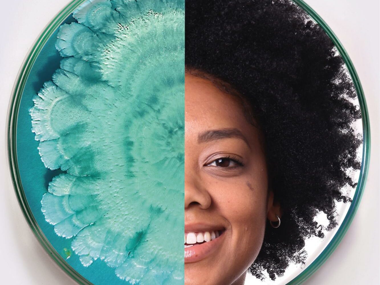 A circular image split in half; the left side features a teal microbial growth pattern, while the right side shows the smiling face of a person with afro-textured hair. The contrasting halves are visually striking.