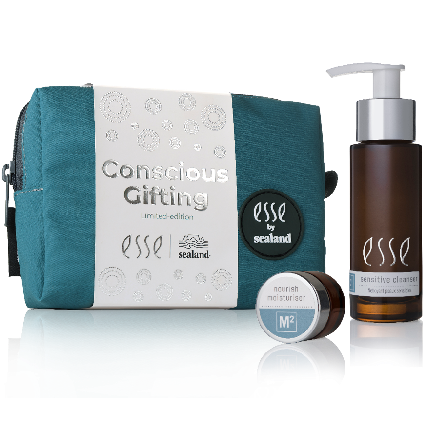 A teal and white "Esse Conscious Gifting" pouch is displayed next to a small Esse moisturizer jar and a brown pump bottle of sensitive cleanser by Esse and Sealand.